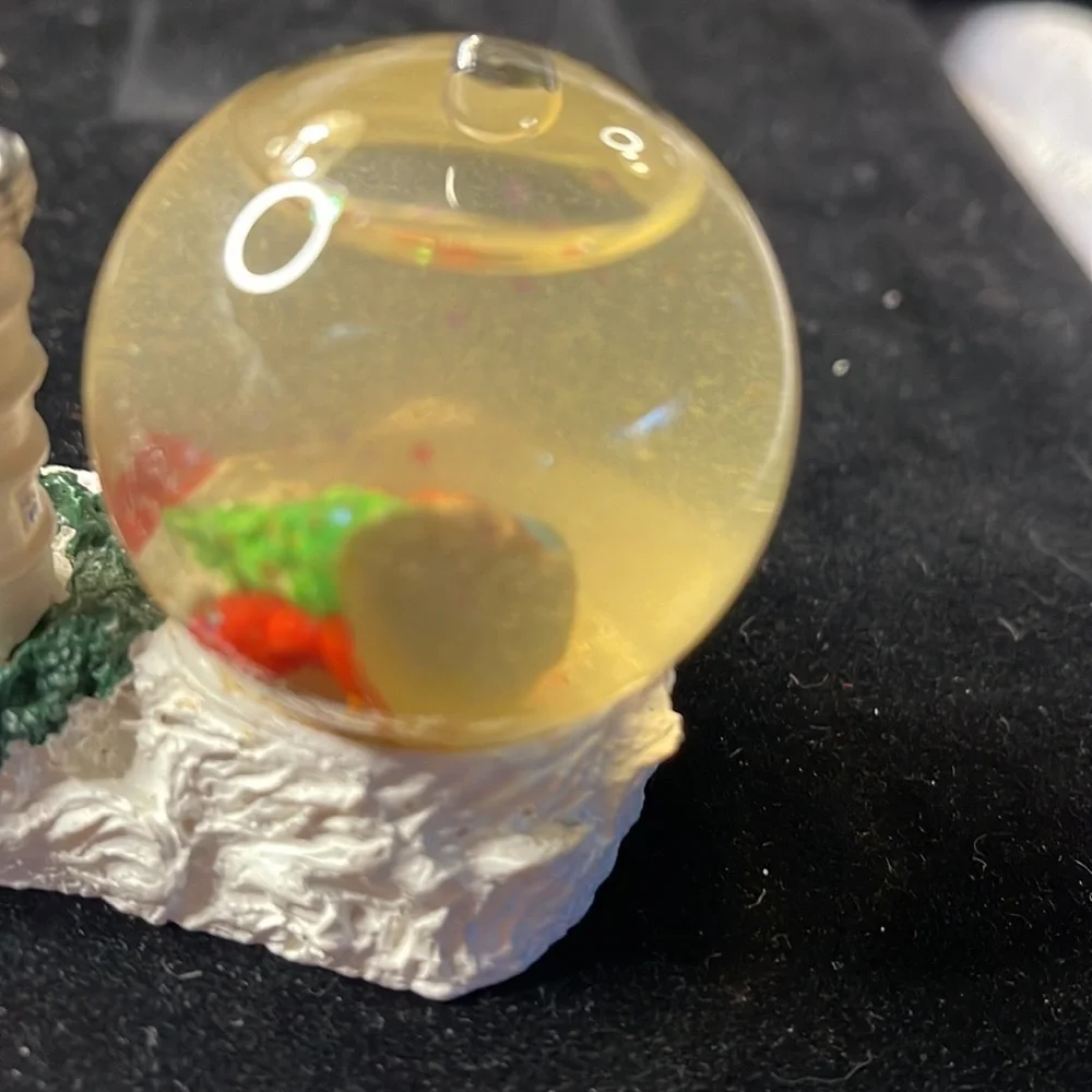 Small Snow Globe Lighthouse w/red roof house-color is clouded Santa is a floater